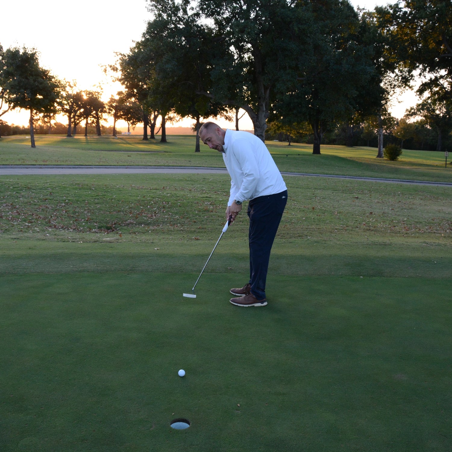 Golfer putting with the Danger Golf Rhyno Putter.